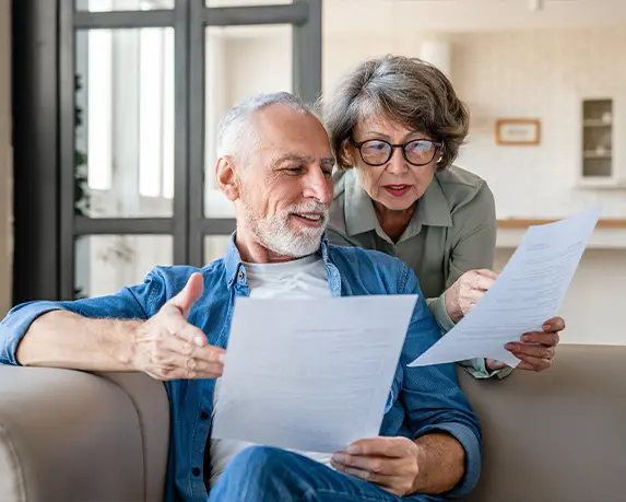 couple looking at financial paperwork together indexed universal life insurance