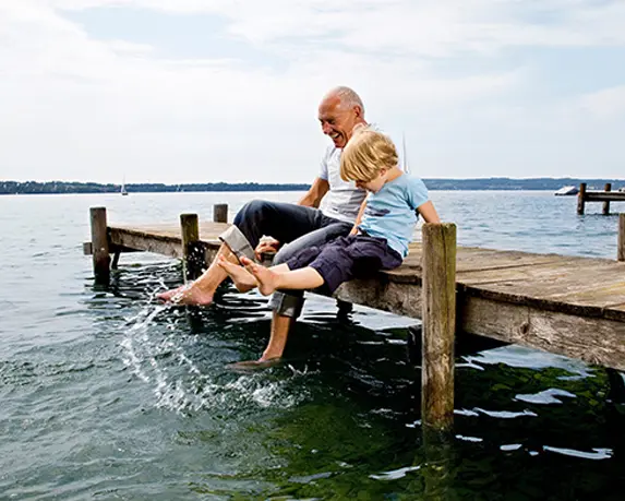 grandfather sitting on the dock with his grandson how annuities work