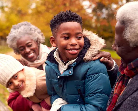 grandparents outside with their grandkids in autumn guaranteed income for retirement