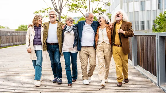 group of senior friends walking in the city